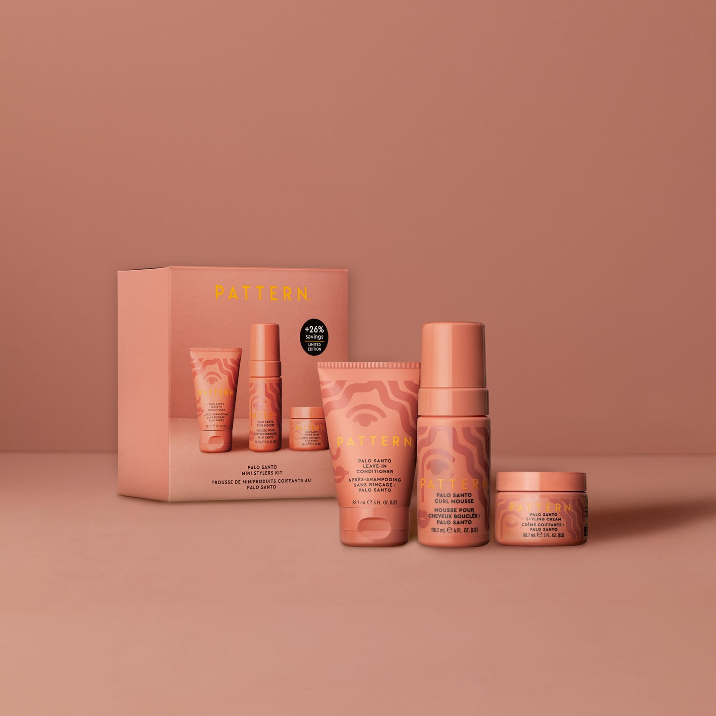 Palo Santo Mini Stylers Kit - PATTERN Beauty by Tracee Ellis Ross Palo Santo Mini Stylers Kit with peach-colored tubes and jars on matching background.