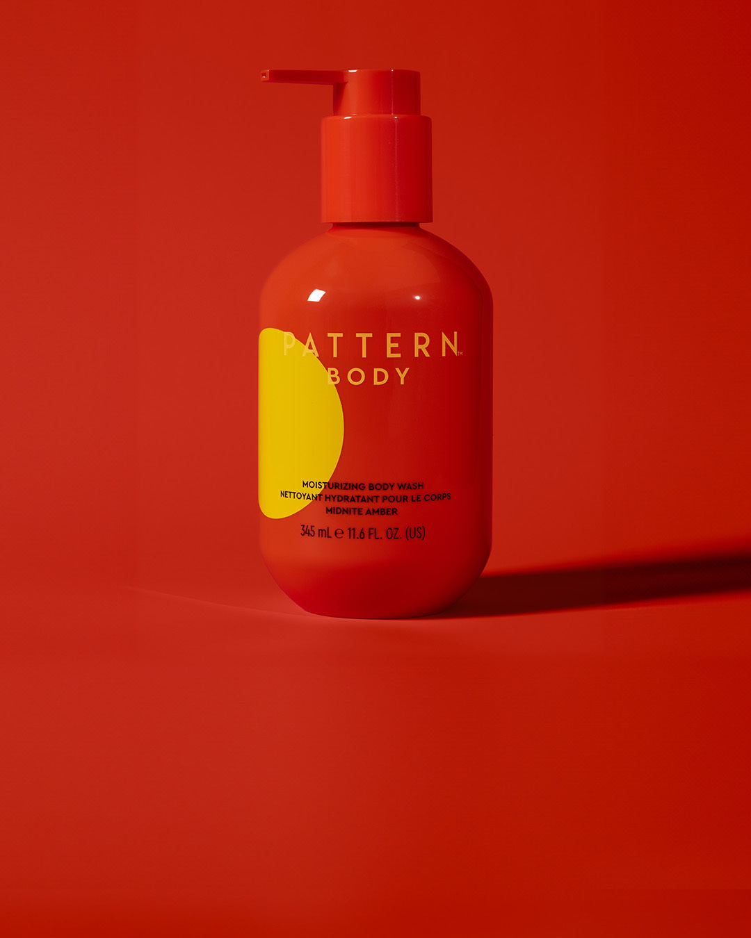 Moisturizing Body Wash - Red pump bottle of PATTERN Beauty by Tracee Ellis Ross moisturizing body wash with yellow design detail.