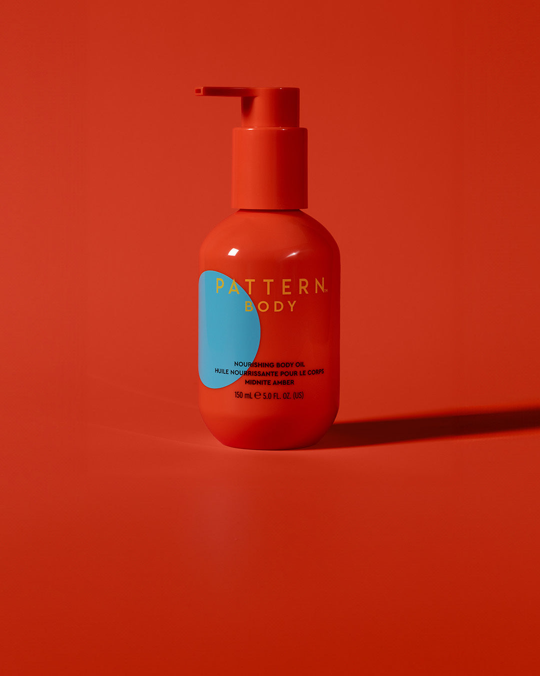 BODY-TEST GWP variant test - Orange pump bottle of PATTERN Beauty by Tracee Ellis Ross hair care on matching orange background.