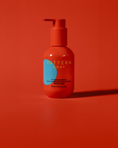 BODY-TEST GWP variant test - Orange pump bottle of PATTERN Beauty by Tracee Ellis Ross hair care on matching orange background.