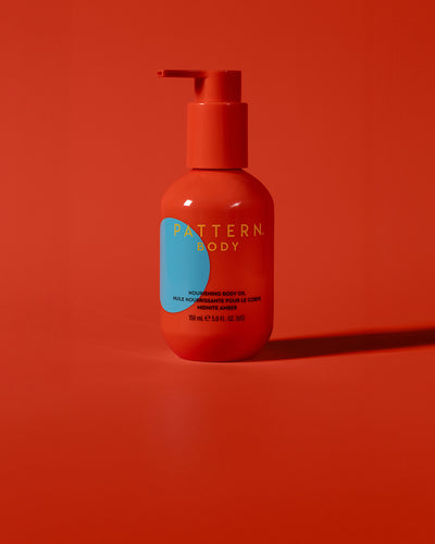 BODY-TEST GWP variant test - Orange pump bottle of PATTERN Beauty by Tracee Ellis Ross hair care on matching orange background.