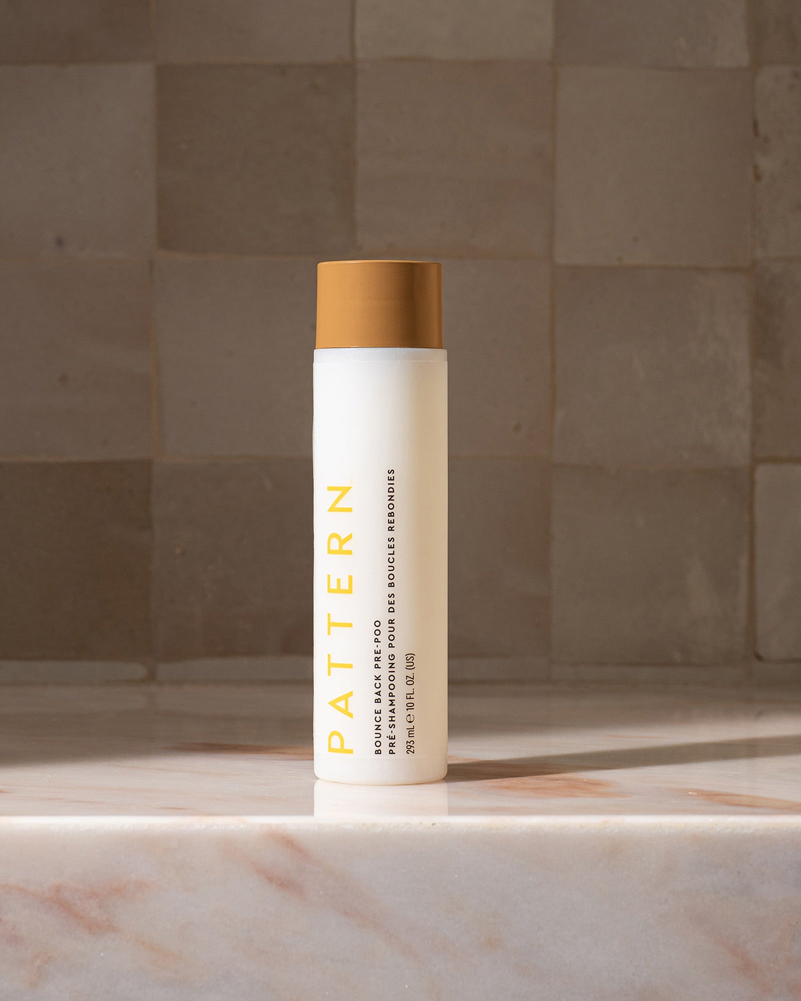 Bounce Back Pre-Poo - White cylindrical bottle with tan cap, yellow "PATTERN" text, and fine print label on front.