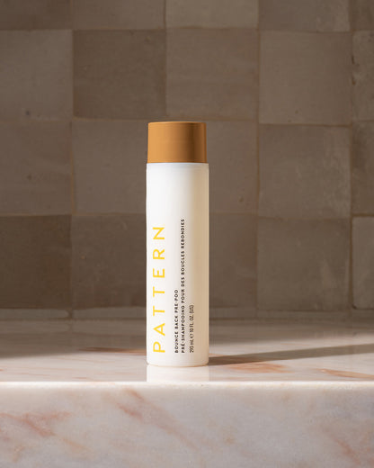 Bounce Back Pre-Poo - White cylindrical bottle with tan cap, yellow "PATTERN" text, and fine print label on front.