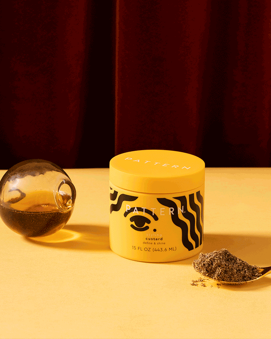 Styling Custard - Yellow jar of PATTERN Beauty by Tracee Ellis Ross Styling Custard with black wavy patterns on label.