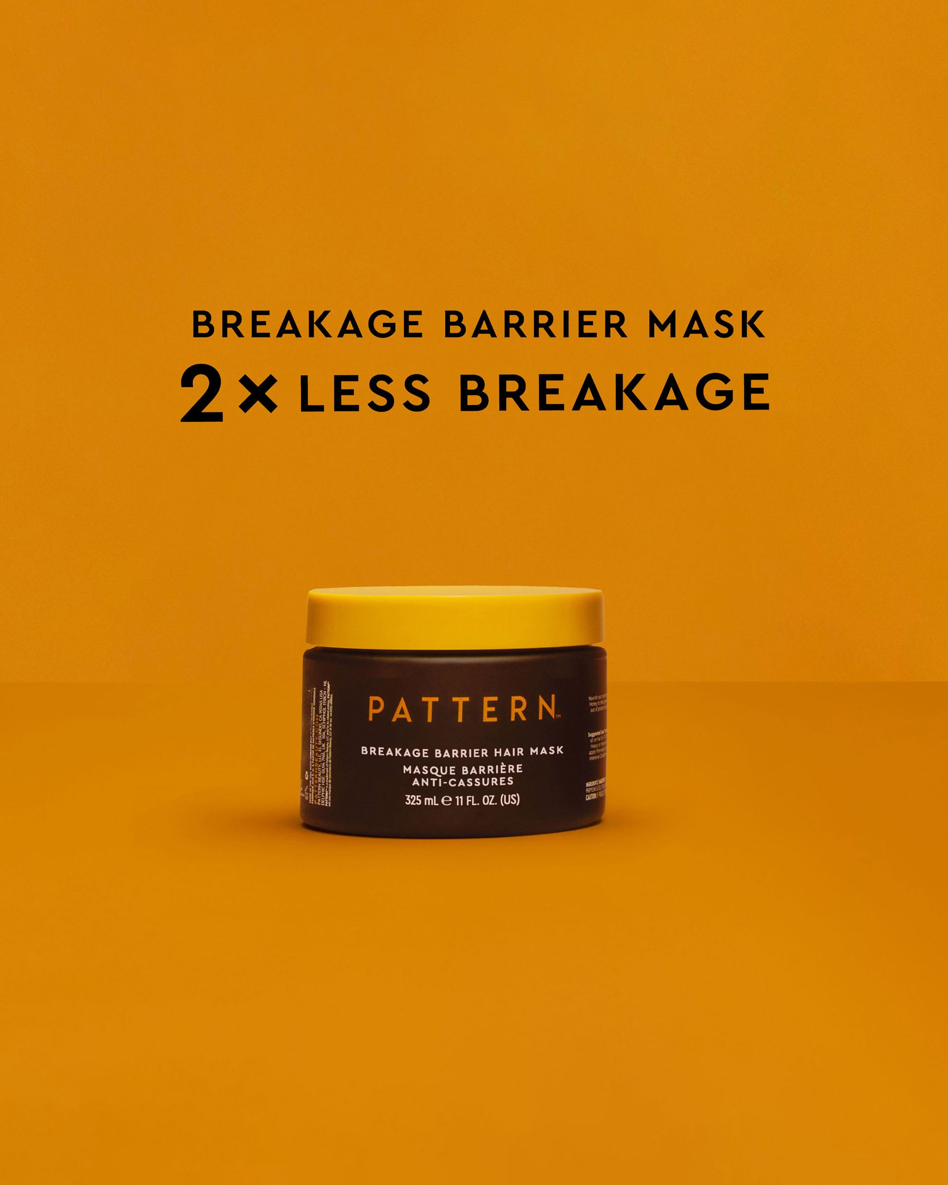 Breakage Barrier Hair Mask - Yellow and black jar of PATTERN Beauty Breakage Barrier Hair Mask with bold text on orange background.