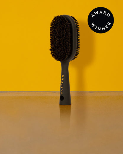Double-Sided Bristle Brush - Black double-sided bristle hairbrush with soft and firm bristles, sleek handle with PATTERN Beauty logo, designed for curly.