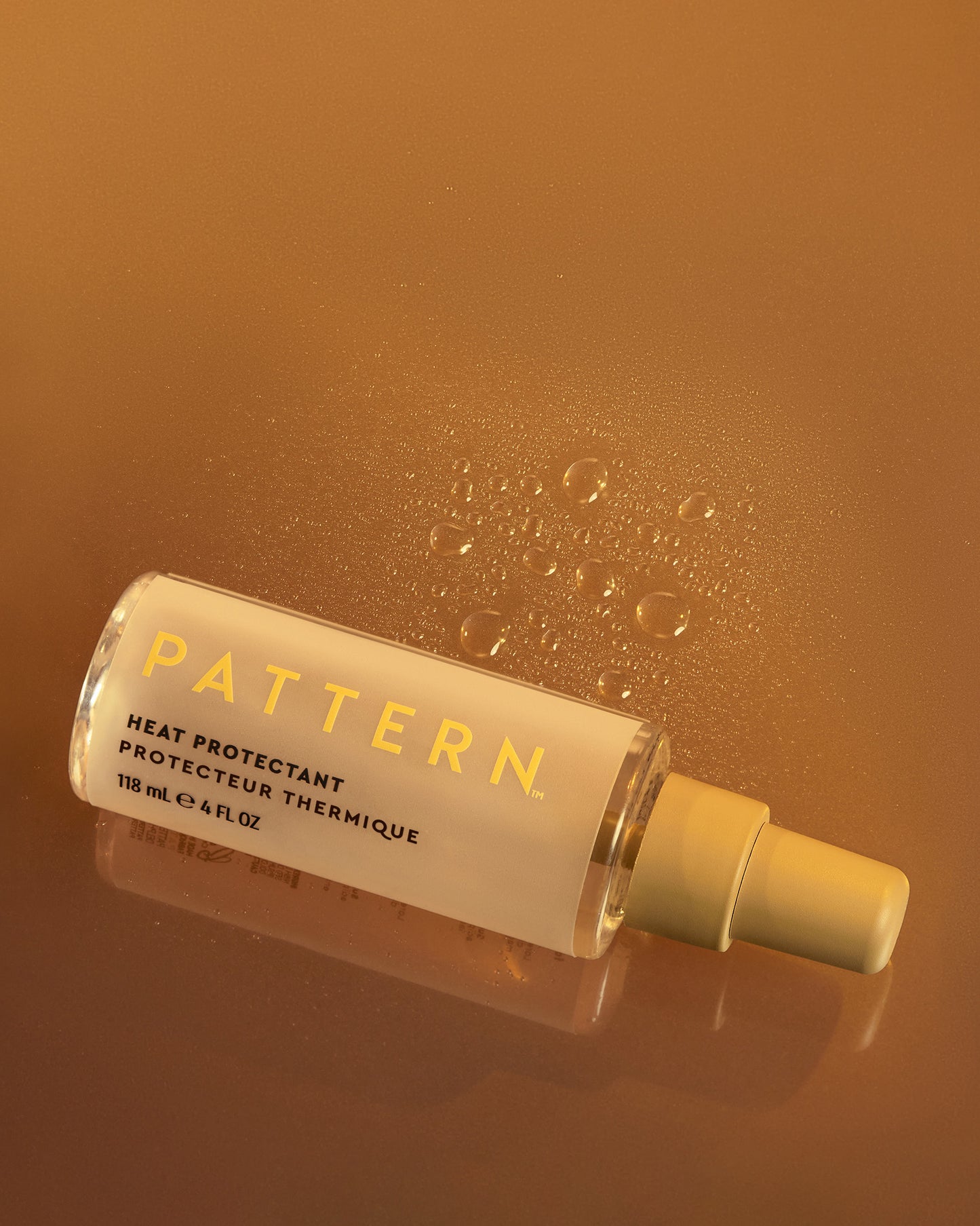 The Heat Bundle - PATTERN Beauty by Tracee Ellis Ross Heat Protectant spray bottle with yellow label on amber background.