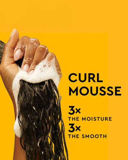 Curl Mousse - Hand holding wet, foamy black curly hair with white curl mousse against bright yellow background with product text.