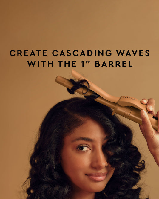 The Curling Iron & More Bundle - PATTERN Beauty by Tracee Ellis Ross Curling Iron with 1-inch barrel held by woman creating cascading waves.