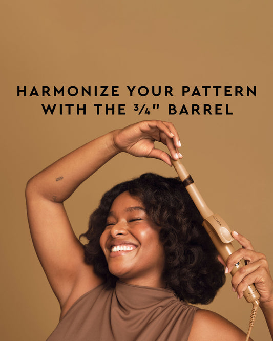 The Curling Iron & More Bundle - PATTERN Beauty by Tracee Ellis Ross 3/4-inch curling iron with gold barrel and black handle in hand.
