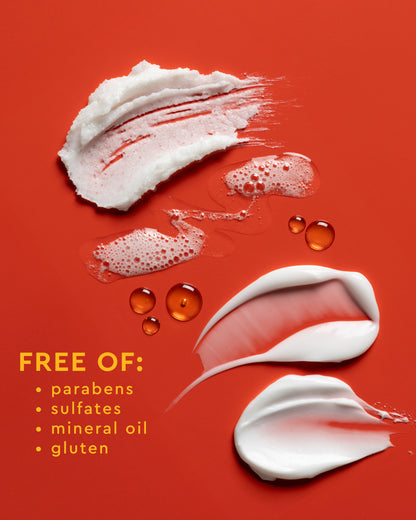 Moisture Rich Body Cream - PATTERN Beauty by Tracee Ellis Ross Moisture Rich Body Cream swatches and water droplets on orange background with product.