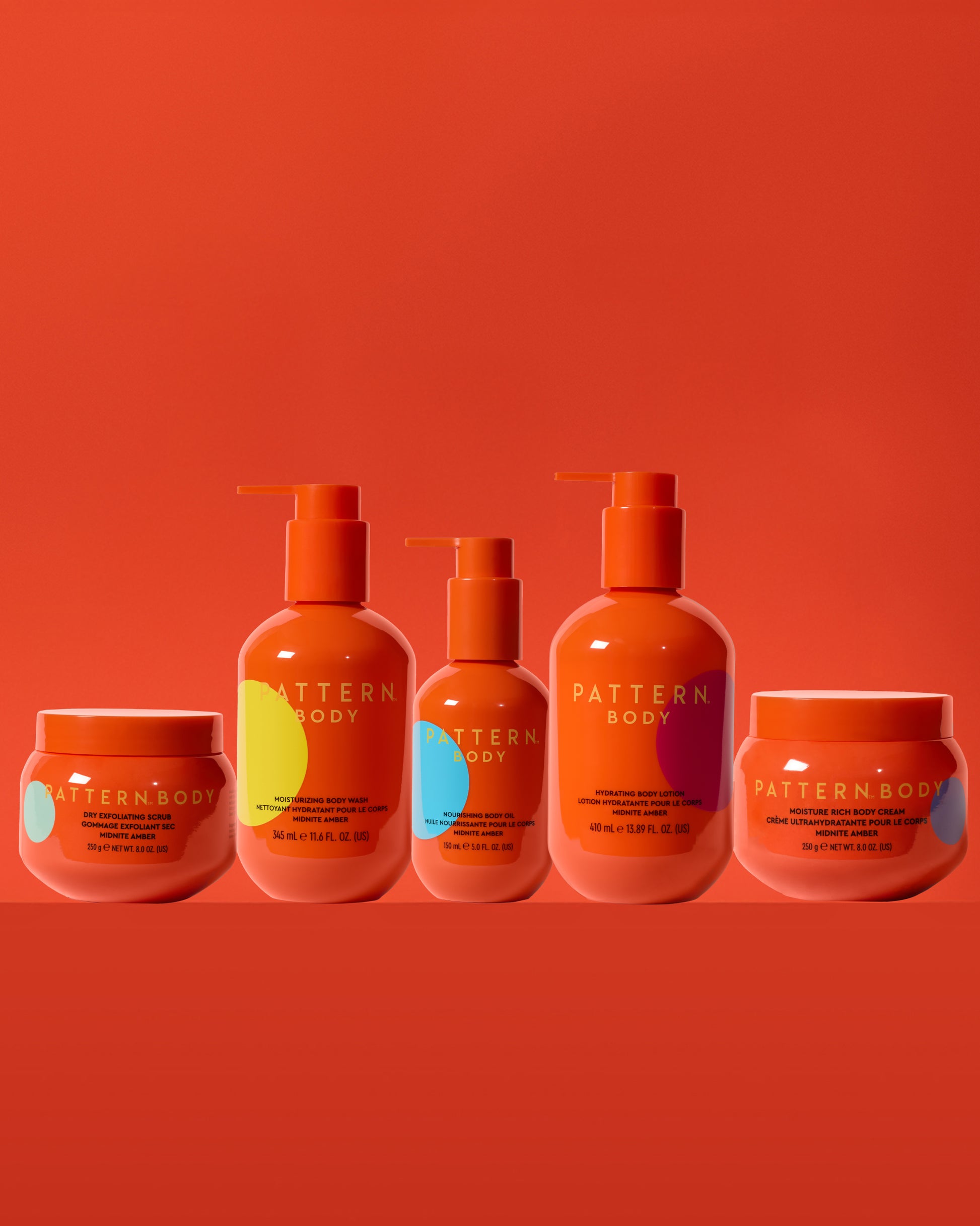 Body Full Collection Bundle - PATTERN Beauty by Tracee Ellis Ross Body Full Collection with five orange bottles and jars on an orange background.