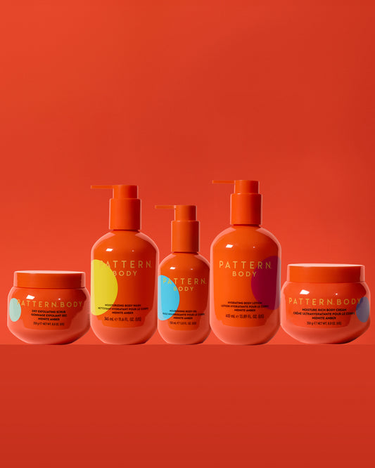 Body Full Collection Bundle - PATTERN Beauty by Tracee Ellis Ross Body Full Collection with five orange bottles and jars on an orange background.