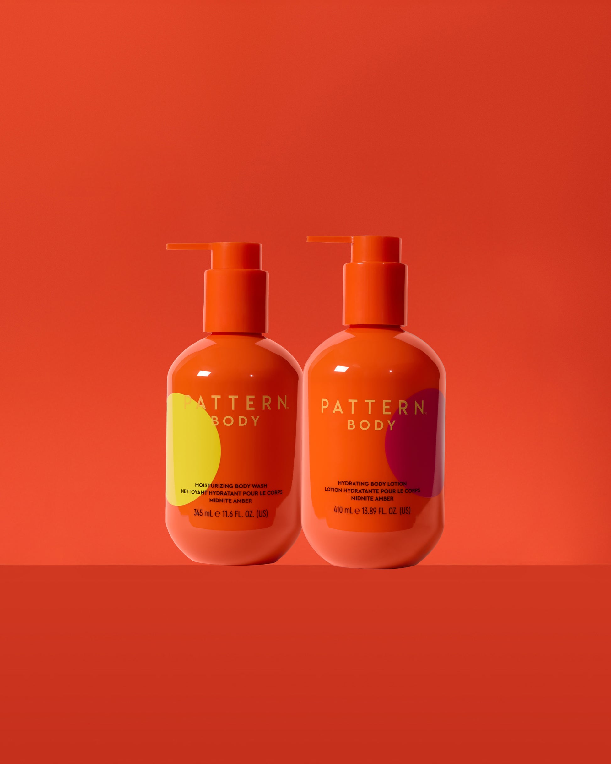 Daily Hydration Body Bundle - Two orange pump bottles of PATTERN Beauty by Tracee Ellis Ross Daily Hydration Body Bundle on orange background.