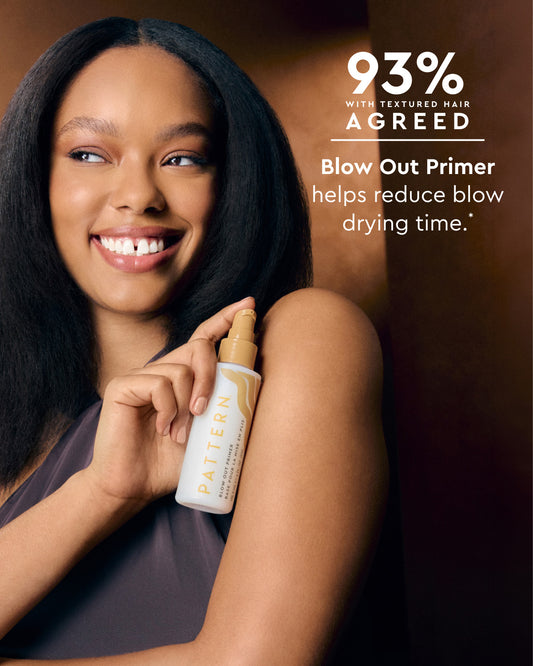 A smiling woman with long dark textured hair holds a bottle of Pattern Blow Out Primer against a warm brown background, with promotional text reading '93% With Textured Hair Agreed' and 'Blow Out Primer helps reduce blow drying time.'.