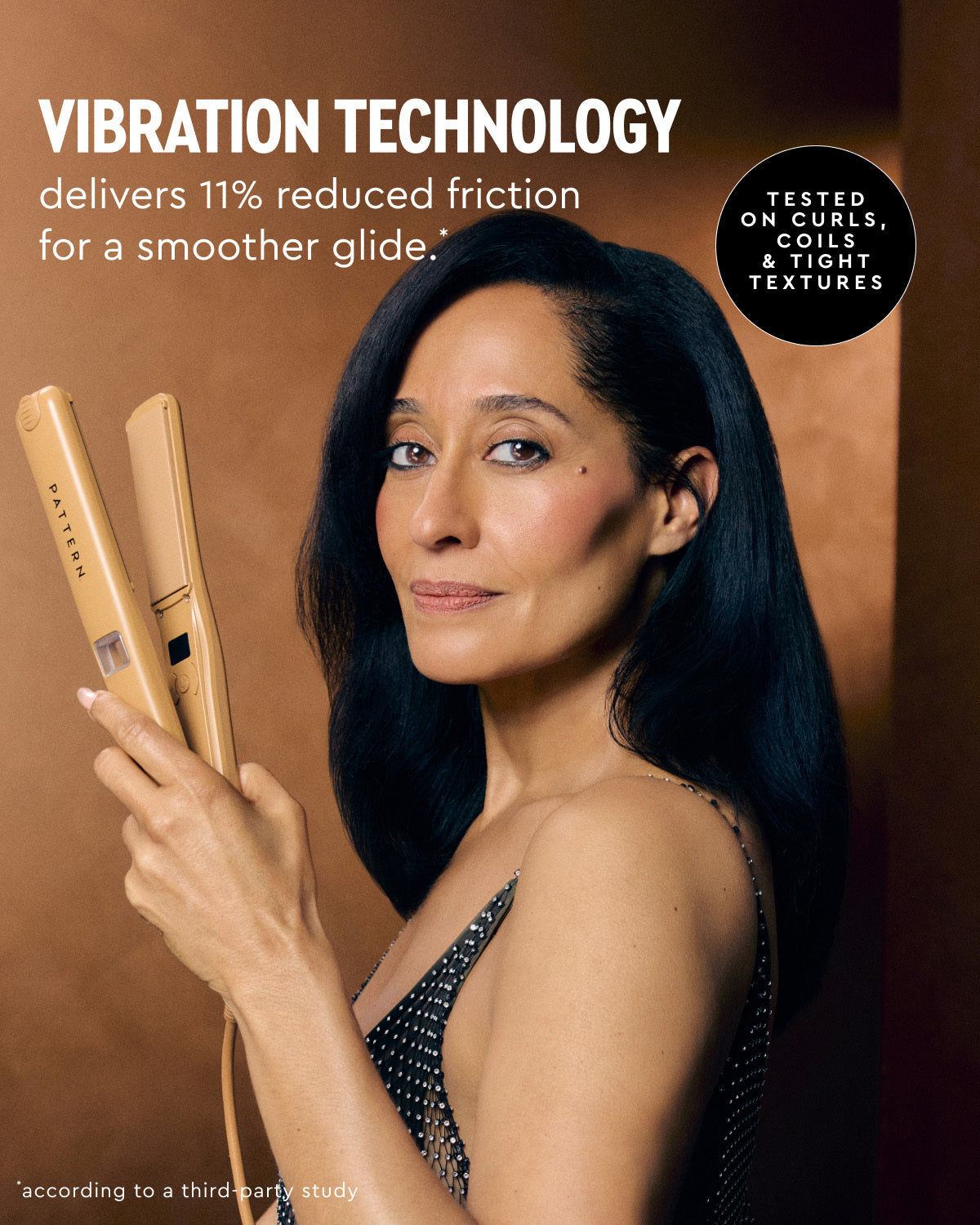 A woman with long dark hair holds a Yvonne flat iron in her hand against a warm brown studio background. Promotional text reads 'VIBRATION TECHNOLOGY delivers 11% reduced friction for a smoother glide.
