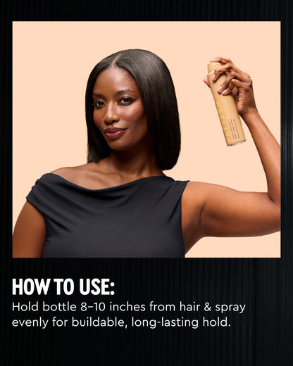 Flexible Hold Spray - PATTERN Beauty by Tracee Ellis Ross Flexible Hold Spray bottle held above a model’s shoulder.