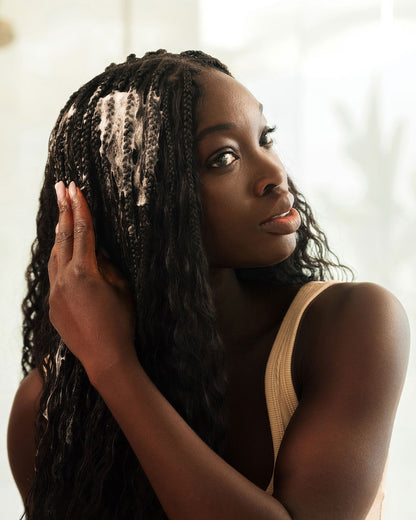 Curl Mousse - PATTERN Beauty Curl Mousse being applied to long textured hair, with foam visible on strands.