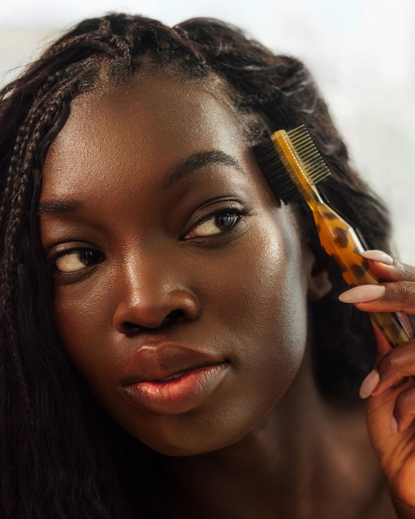Tortoise Tool Kit with Pick - PATTERN Beauty by Tracee Ellis Ross tortoise hair tool kit with gold and tortoise pick comb held by woman with long braids.