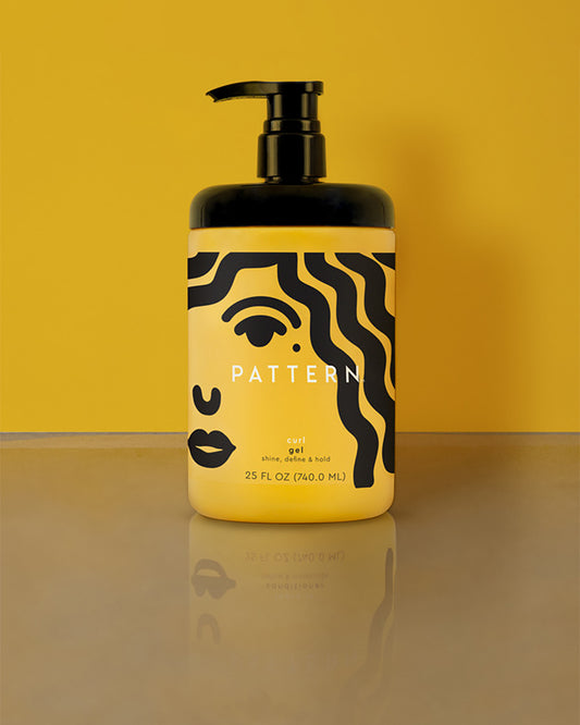 Curl Gel - Yellow plastic bottle of Pattern Beauty Curl Gel with black pump and abstract black face design on label.