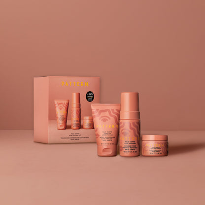 Palo Santo Mini Stylers Kit - PATTERN Beauty by Tracee Ellis Ross Palo Santo Mini Stylers Kit with peach-colored tubes and jars on matching background.
