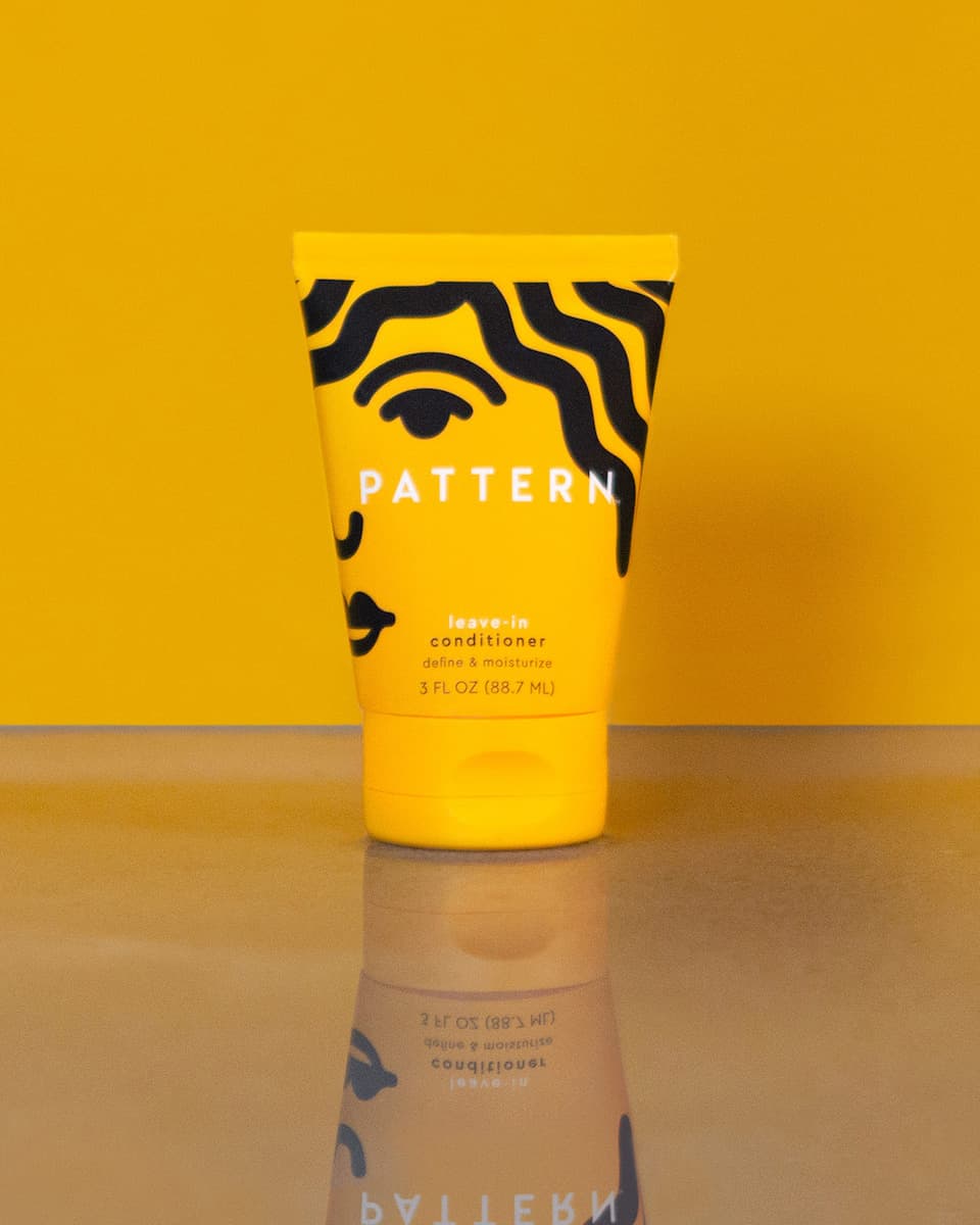 Leave-In Conditioner 3 FL OZ (88.7 ML)- Yellow PATTERN Beauty leave-in conditioner tube with bold black wavy stripes and a flip-top cap.