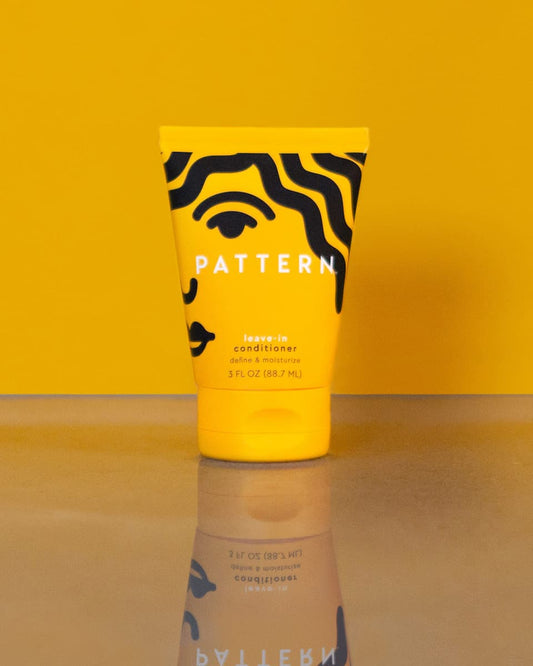Leave-In Conditioner 3 FL OZ (88.7 ML)- Yellow PATTERN Beauty leave-in conditioner tube with bold black wavy stripes and a flip-top cap.