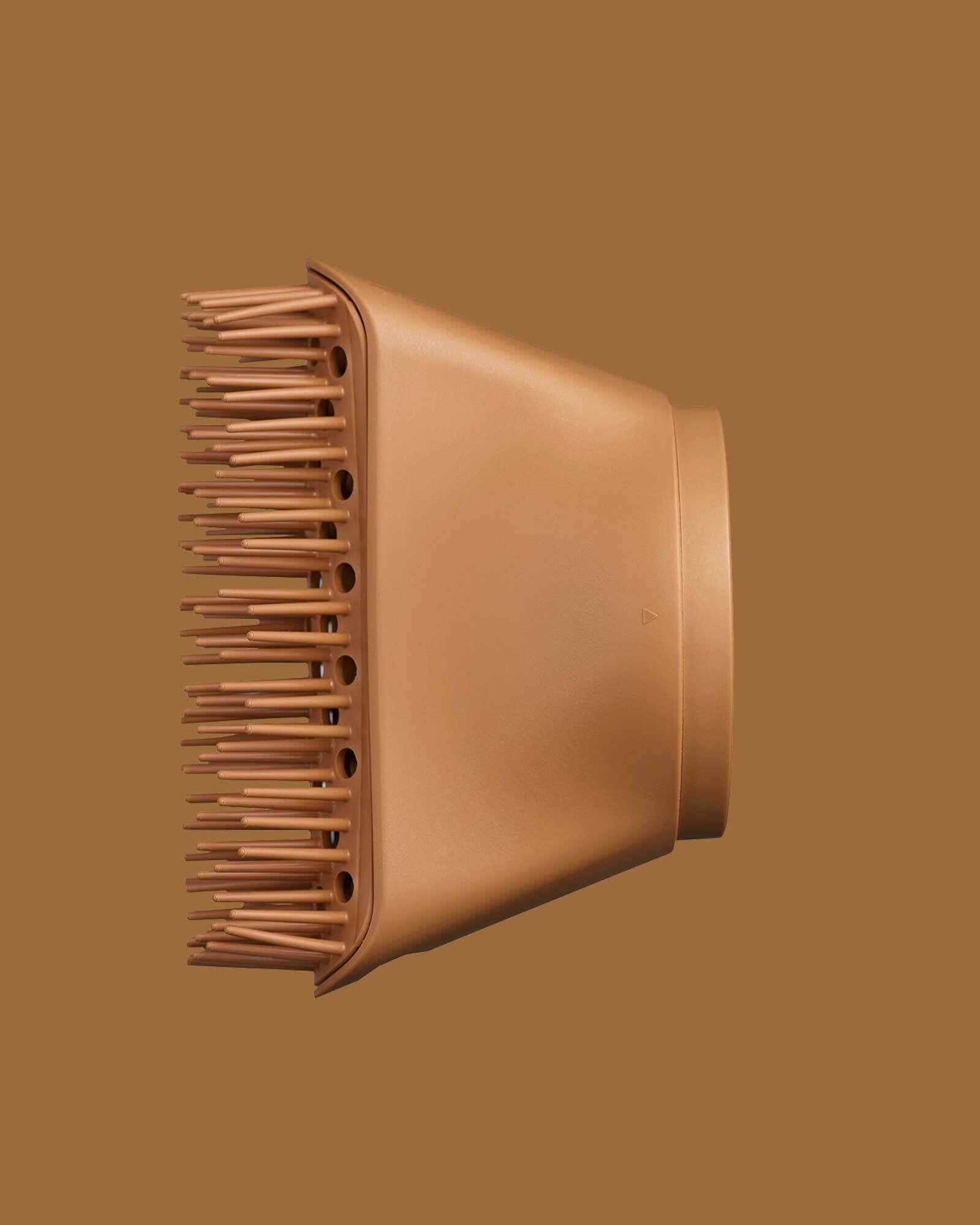 The PATTERN Blow Dryer - Copper-colored hair dryer diffuser attachment with wide, evenly spaced prongs and smooth matte finish.