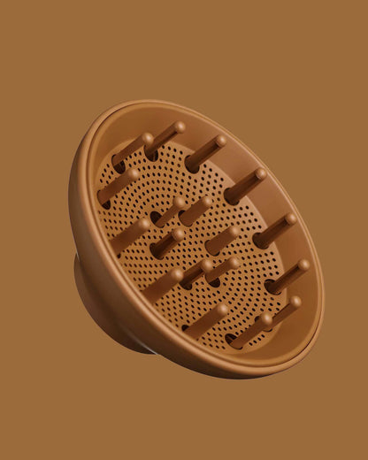 The PATTERN Blow Dryer - Brown plastic hair diffuser attachment with multiple prongs and ventilated holes for airflow.
