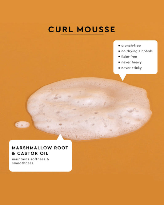 Palo Santo Curl Mousse - White frothy curl mousse foam on orange background with text highlighting marshmallow root and castor oil ingredients.