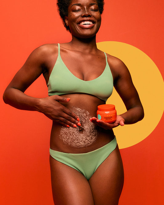 Radiant Skin Trio - Woman in green bra and underwear applying PATTERN Beauty by Tracee Ellis Ross Radiant Skin Trio cream to her torso.